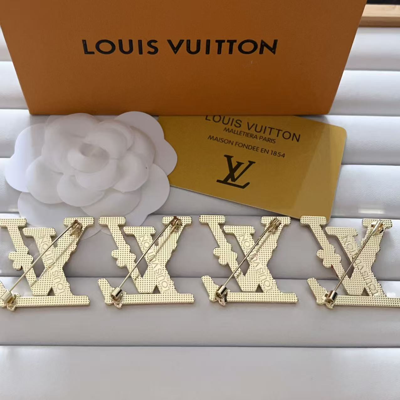 New LV brooch, with label.