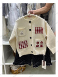 Girls cream knit cardigan with red plaid pockets and bunny patch